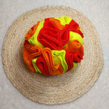 Load image into Gallery viewer, Orange, Yellow and red dog toy made out of fleece fabric sitting on a light coloured background.