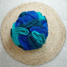 Load image into Gallery viewer, Teal, purple and turquoise coloured fleece dog toy sitting on a light coloured background.
