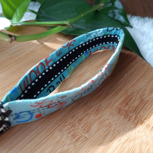 Load image into Gallery viewer, Carry your keys in style with these wrist lanyards made in various pet themed fabrics. &#39;Dog Words&#39; Version - Measures 5.5&quot; long x 1&quot; wide. Happy Dogs&#39; Version - Measures 6&quot; long x 1&quot; wide. Reinforced with twill tape, double stitching and interfacing for stiffness. Stainless steel D-ring measures ¾&quot; in diameter with an attached swiveling lobster clasp. 1” Stainless steel key ring included. Wiggles and Whiskers Canada Pet Accessories.
