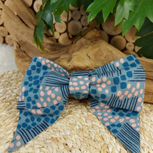 Load image into Gallery viewer, Abstract Teal with Pink Collar Bow. Help your pup put their best paw forward by wearing one of these pretty bows on their collar. Worn to the side, up front or at the back, its versatility makes dressing up an everyday possibility! This collar bow is suitable as a cat collar and a dog collar. Measures 5.5” at its widest point. Made from 100% cotton fabric in a variety of patterns. Fastens to collars up to 1” wide. Elastic and snap fastener. Wiggles and Whiskers Canada Pet Accessories.