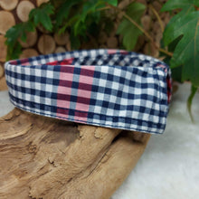 Load image into Gallery viewer, Blue, Red and White Plaid Dapper Pet Collar. Your dog or cat will look “Oh so handsome” in a snap, with this simple, comfortable and stylish collar available in a variety of classic looks. This dog collar is suitable to be used as a cat collar. The neck size is 14.5 inches. Made of 100% cotton fabric. Fully washable, dryer friendly and can be ironed as needed. It is recommended that you allow an additional 2 finger widths space for ideal fit. Wiggles and Whiskers Canada Pet Accessories.
