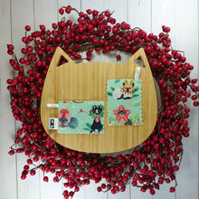 Load image into Gallery viewer, Artificial red berry wreath with cat shaped wooden board in the middle with two rectangular shaped catnip pouches made out of green fabric with cats on them in the middle. 
