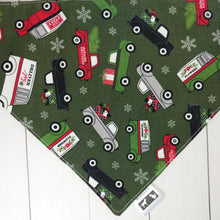 Load image into Gallery viewer, Dog Bandana made out of green fabric with Christmas trucks  laying flat on a white background 
