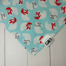 Load image into Gallery viewer, Dog Bandana made out of fabric with polar bears on a light blue background laying flat on a white background .
