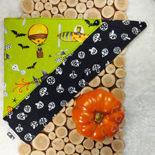 Load image into Gallery viewer, dog bandana made out of halloween themed fabrics folded almost in half and laying flat on runner made of wood cutouts on top of white faux fur with small fake pumpkin beside it.
