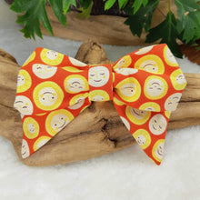 Load image into Gallery viewer, Hello Sunshine Collar Bow. Help your pup put their best paw forward by wearing one of these pretty bows on their collar. Worn to the side, up front or at the back, its versatility makes dressing up an everyday possibility! This collar bow is suitable as a cat collar and a dog collar.  Measures 5.5” at its widest point. Made from 100% cotton fabric in a variety of patterns. Fastens to collars up to 1” wide. Elastic and snap fastener. Wiggles and Whiskers Canada Pet Accessories.
