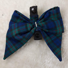 Load image into Gallery viewer, Plaid Collar Bow. Help your pup put their best paw forward by wearing one of these pretty bows on their collar. Worn to the side, up front or at the back, its versatility makes dressing up an everyday possibility! This collar bow is suitable as a cat collar and a dog collar.  Measures 5.5” at its widest point. Made from 100% cotton fabric in a variety of patterns. Fastens to collars up to 1” wide. Elastic and snap fastener. Wiggles and Whiskers Canada Pet Accessories.
