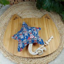 Load image into Gallery viewer, Sock Monkey Shooting Star Catnip Toy. Stimulate all your cat’s senses with this catnip toy! Star shaped flannel toy with string dangle with monkey pattern on one side. Measures 5.5” across and 11” in total length. The other side of this catnip toy is polka dot patterned in red and white. Wiggles &amp; Whiskers. Pet Accessories Canada.
